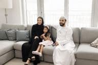 Happy loving Arab family with young parents.