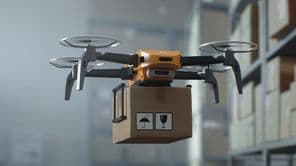 Pilotless UAV Drone Delivering Cardboard Box.