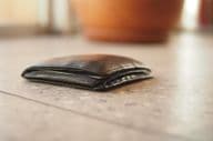 Black leather wallet found on the floor.
