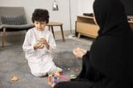 Young Arab woman teaching with creative toys at a Muslim home.