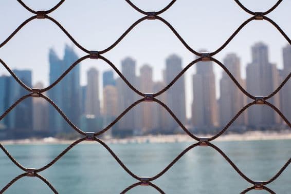 View of skyscrapers in Dubai through the iron bars.