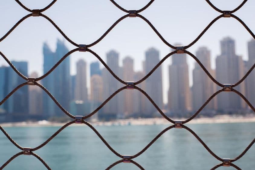 View of skyscrapers in Dubai through the iron bars.