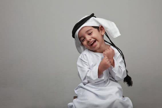 Young boy in traditional Arab attire.