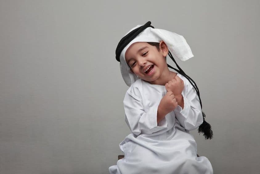 Young boy in traditional Arab attire.