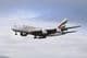 Emirates Airbus 380-800 airplane approaching the runway for landing.