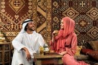 Young Emirati couple spending time in a traditional Arabic café.