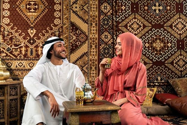 Young Emirati couple spending time in a traditional Arabic café.