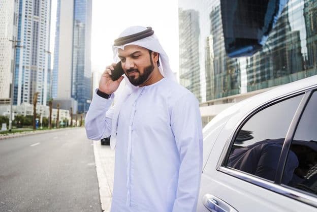 Arab businessman wearing kandura - Traditional Emirati male attire.