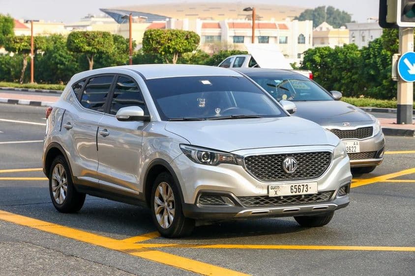 Small crossover SUV MG on an urban street.