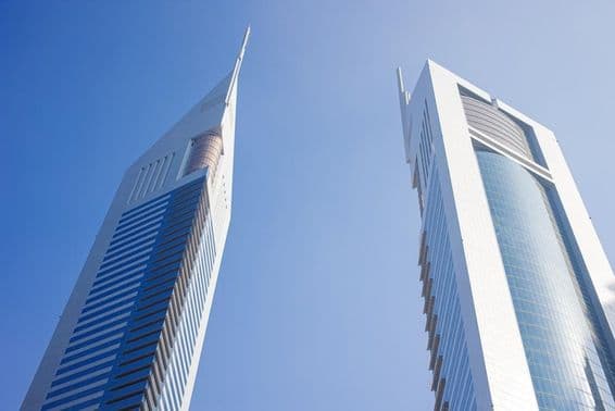 Two skyscrapers under a blue sky.