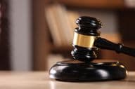 Judge's gavel on a wooden desk.