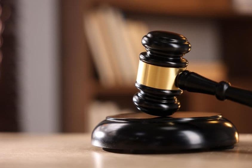 Judge's gavel on a wooden desk.
