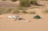 Metal, plastic, and other waste left by people pollute the desert environment in Dubai.