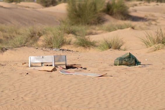 Metal, plastic, and other waste left by people pollute the desert environment in Dubai.