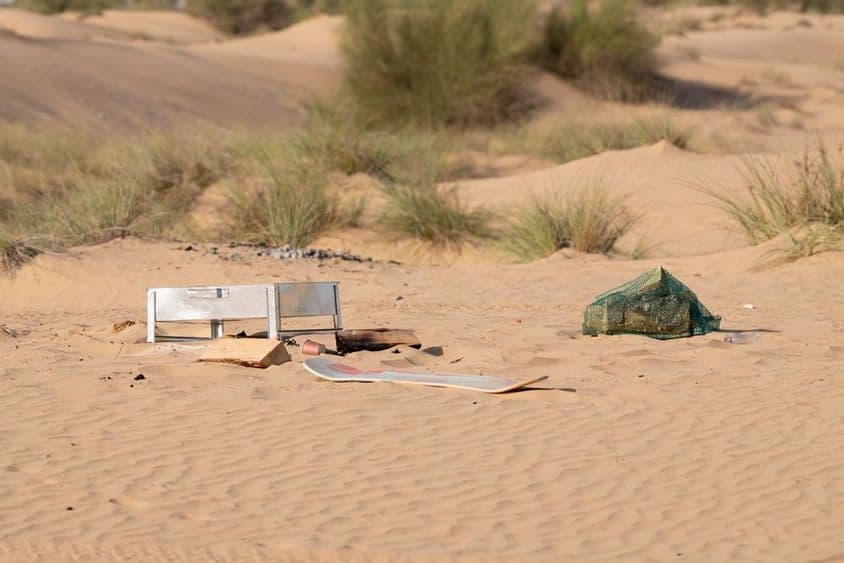Metal, plastic, and other waste left by people pollute the desert environment in Dubai.