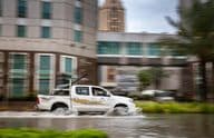 Car driving through a flooded street in Dubai.