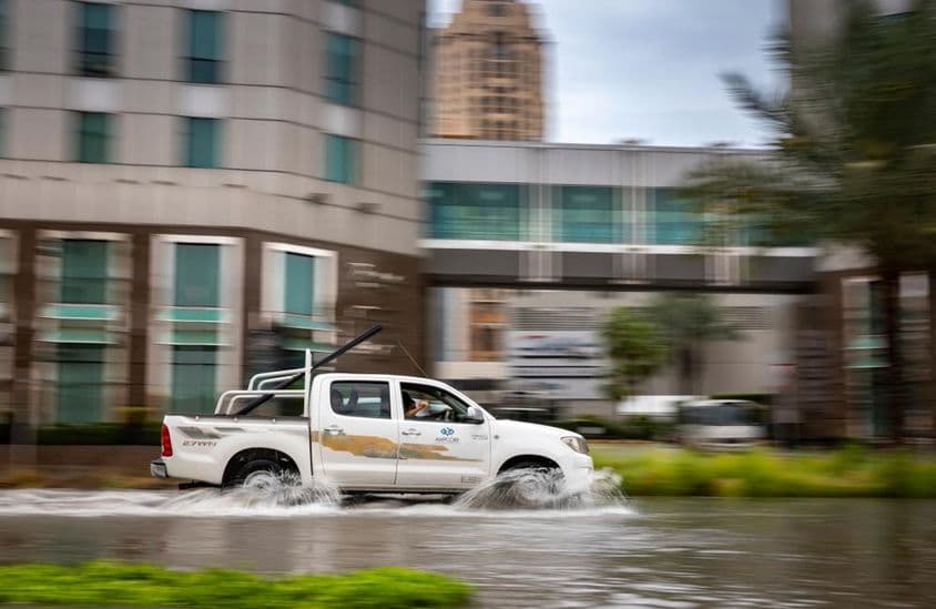 Car driving through a flooded street in Dubai.