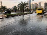 Traffic moving through a flooded urban road in Dubai.
