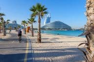 View of Burj Al Arab along a bike path at Kite Beach Dubai.