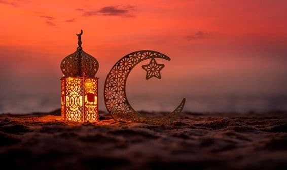Traditional lantern with crescent moon on the beach.