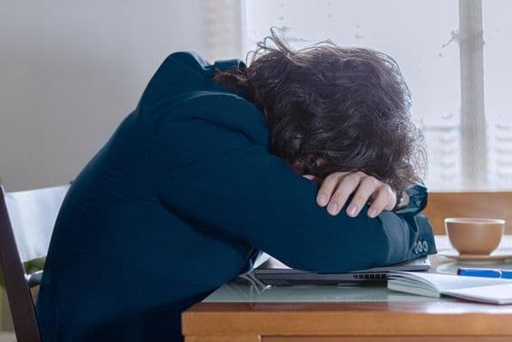 A person resting on their laptop at work on a Monday.