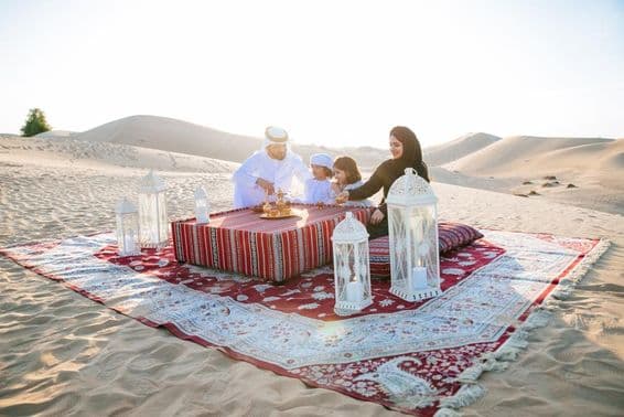 Happy family enjoying a wonderful day picnicking in the desert.