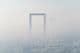 Stunning panorama in fog of the world's largest gold frame made in Dubai.