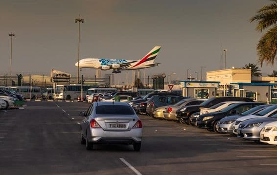 An Emirates Airlines plane landing at Dubai International Airport's Terminal 2.