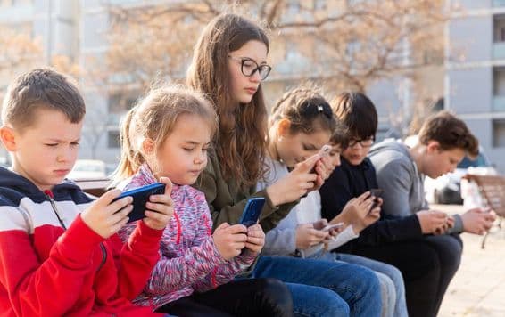 Children communicating via messaging on a smartphone.