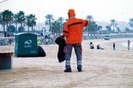 Dubai, United Arab Emirates, worker cleaning the beach.