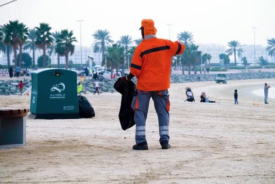 Dubai, United Arab Emirates, worker cleaning the beach.