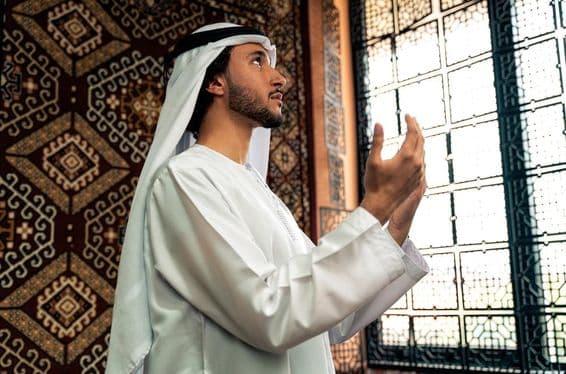 A young man praying in the mosque.