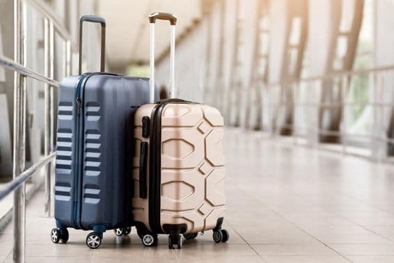 Luggage suitcases waiting in the terminal hall.