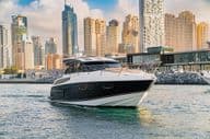 A luxury yacht in Dubai with skyline and skyscrapers.