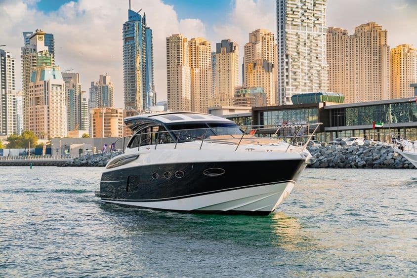 A luxury yacht in Dubai with skyline and skyscrapers.