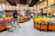 Courier selecting vegetables and fruits in a supermarket.