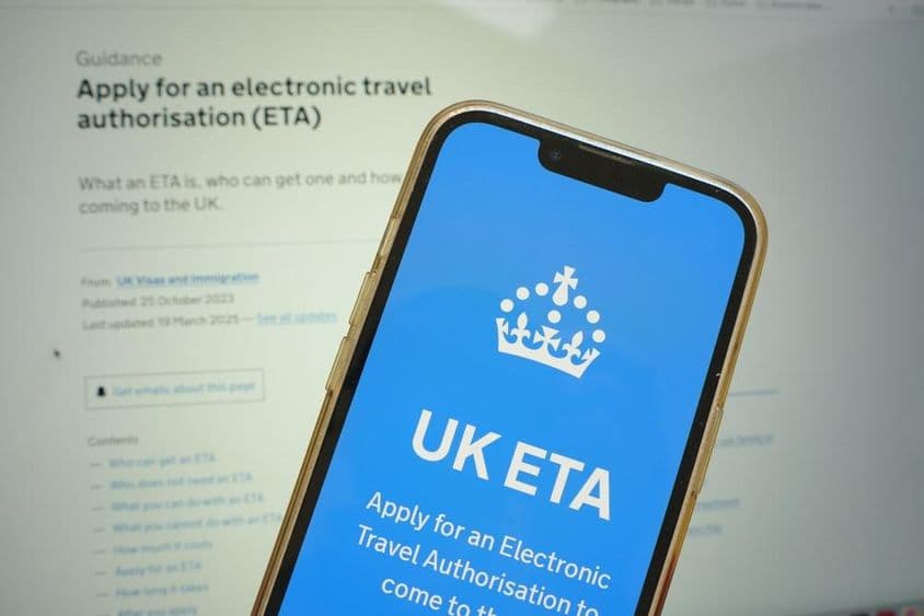Mobile phone showing UK Electronic Travel Authorization (ETA) application process.