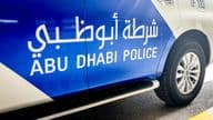 Abu Dhabi police car with English and Arabic lettering.