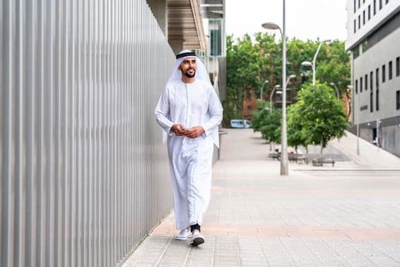 Arab Muslim businessman walking in the city's business district.