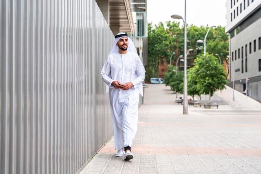 Arab Muslim businessman walking in the city's business district.