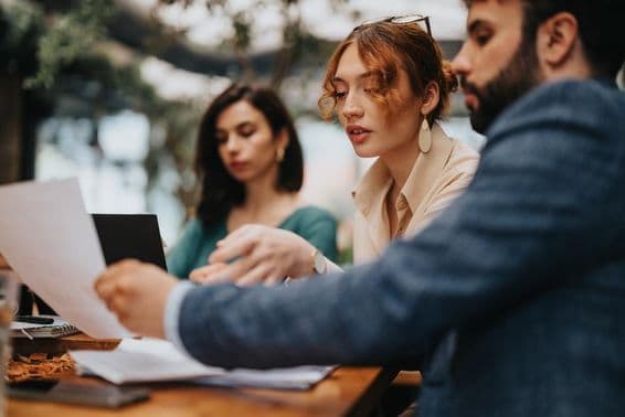 Business people in a café focused on strategy planning.