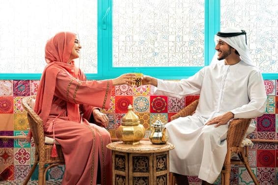 Young Emirati couple spending time in a traditional Arabic café.
