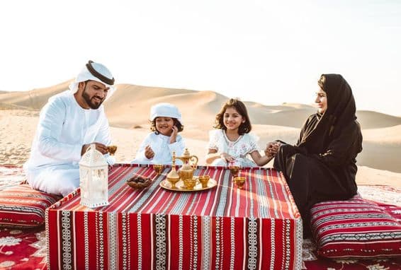 Arab family spending a weekend in the Dubai desert.