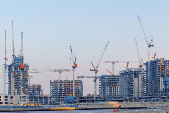 Real estate construction at Dubai Creek Harbor, cranes, unfinished towers.