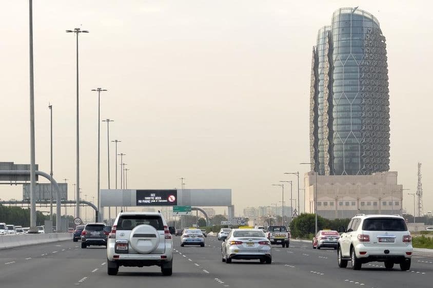 A busy Al Salam Street in Abu Dhabi with vehicles.
