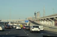 Traffic congestion during rush hour in Dubai with Dubai's famous skyscrapers in the background.