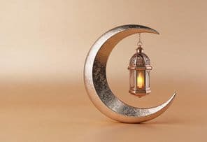 Decorative crescent with a glowing Ramadan lamp.