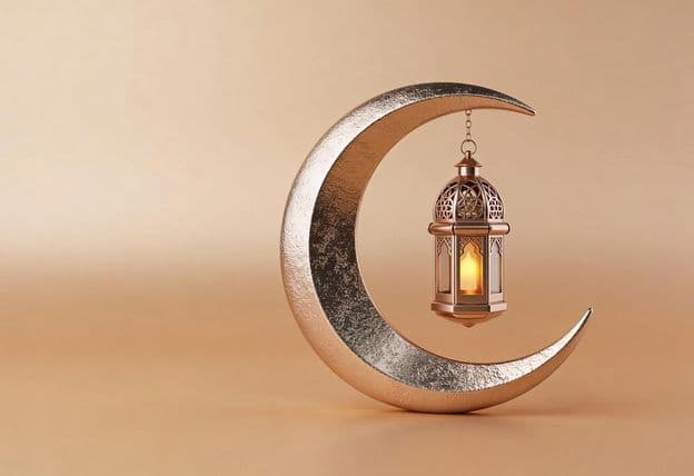 Decorative crescent with a glowing Ramadan lamp.