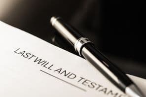 Close-up view of a will document with a slim pen.