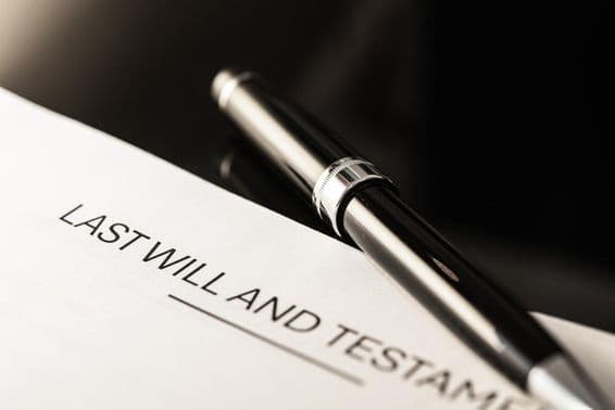 Close-up view of a will document with a slim pen.